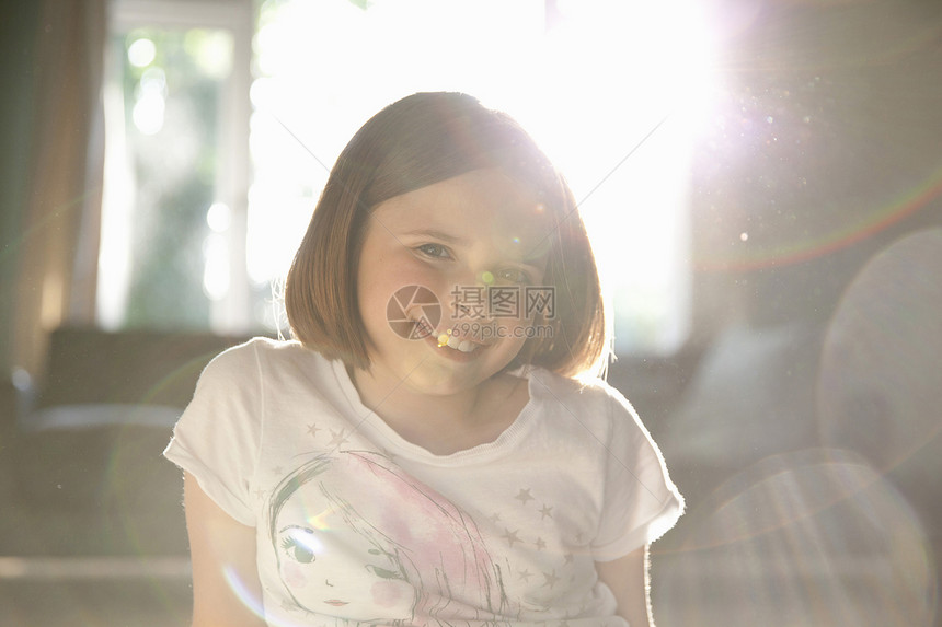 阳光照亮微笑女孩的肖像图片
