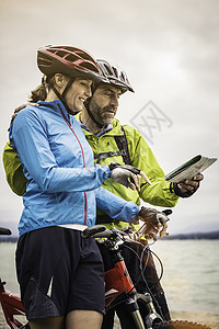 喜马拉雅山上骑双车在湖边阅读的情侣背景图片
