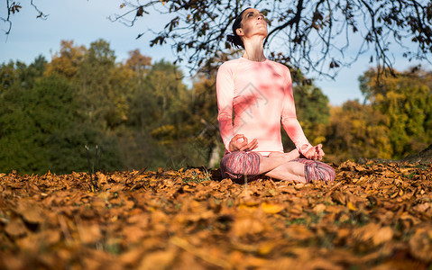 秋天在公园做瑜伽的女人图片