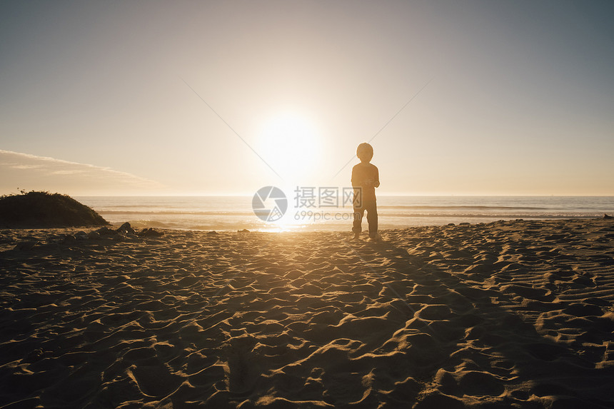 美国加利福尼亚州海滩上站在的小男孩图片