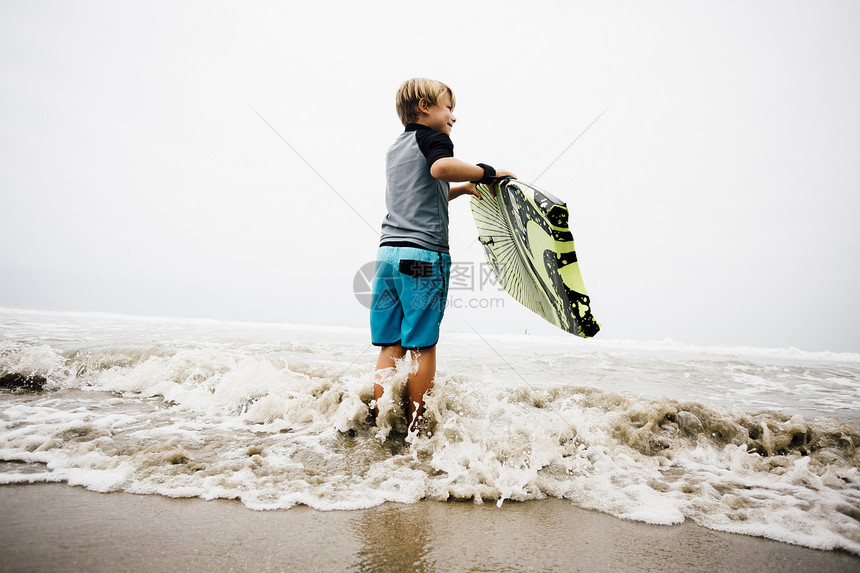 年轻男孩站在海上抱着身体图片