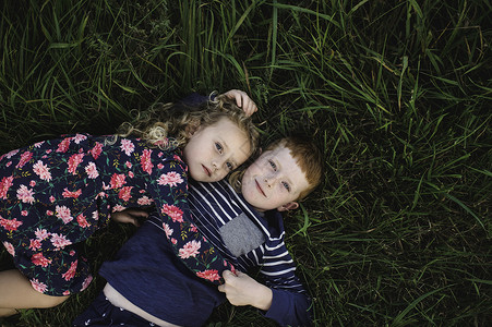 男孩和女孩躺在草地上图片