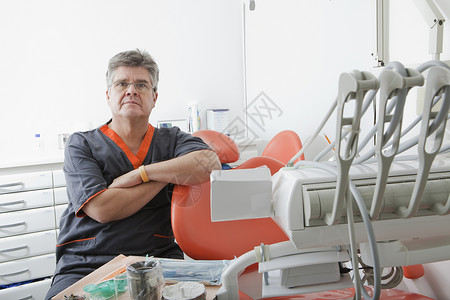牙科医坐在椅旁图片