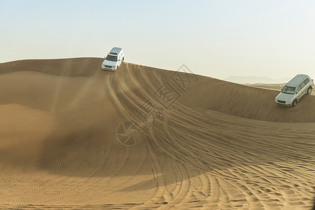 沿沙漠丘行驶的越野公路车辆阿拉伯联合酋长国迪拜图片