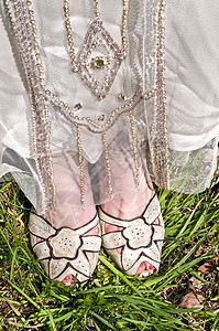 新娘穿着礼服和鞋子站在草地上图片