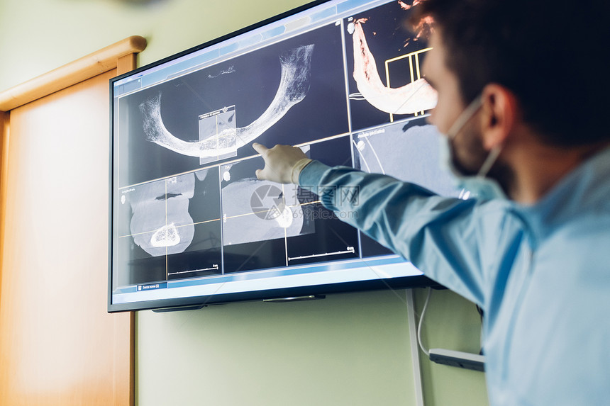 医生指着牙科X光片图片