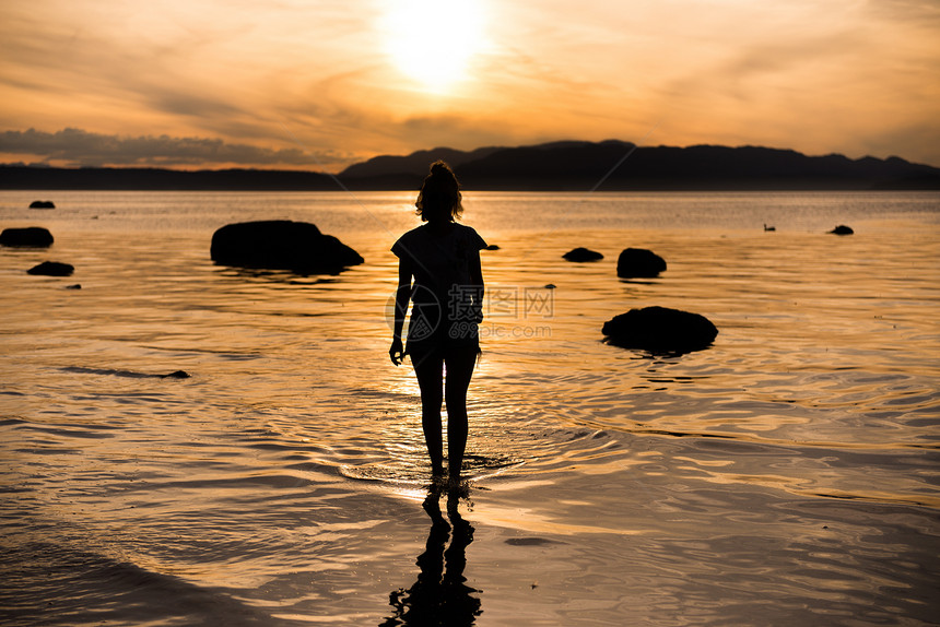 加拿大坎贝尔河岛年轻女子仰望日落图片