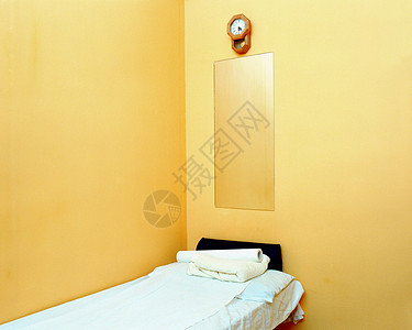 橙色房间里的空床背景图片