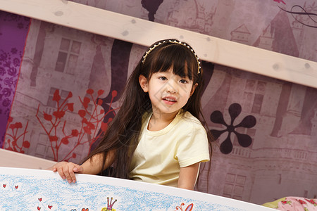 被子卡通放松可爱的小女孩在床上玩耍背景