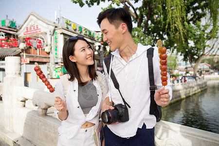 情侣游船大学生青年情侣旅游拿着糖葫芦背景