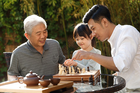 和爸爸下棋祖孙三代在庭院里下棋背景