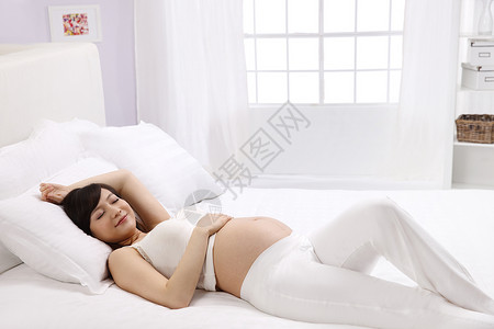 肖像窗户放松孕妇躺在床上睡觉图片