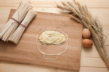木制菜板健康食品挂面麦穗鸡蛋背景
