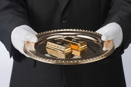 财富管家海报手托餐盘里的金条背景