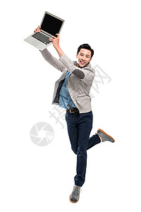 拿着笔记本电脑跳跃的青年商务男士图片
