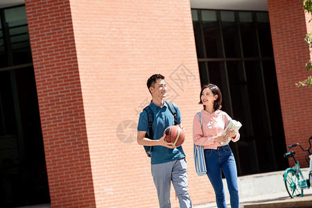 大学生情侣步行在校园里图片