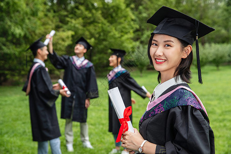 新毕业生户外穿着学士服的大学生们背景