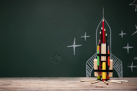 火箭玩具黑板画和文具组成的创意火箭背景