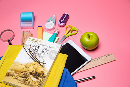 荧光色苹果标志书包里的学习用品和苹果背景