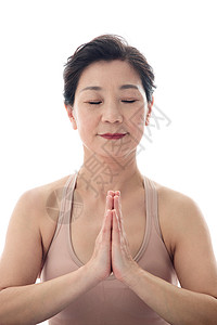 双手合十练瑜伽的中年女士特写图片
