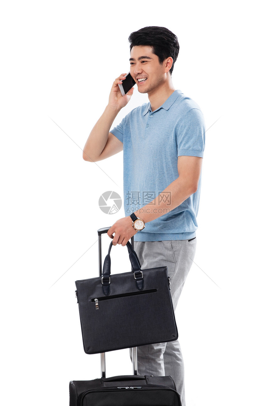 大半身乐趣旅行箱拿行李箱的商务男士打电话图片
