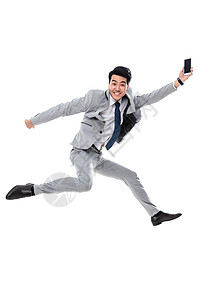 享乐衬衫领带半空中拿着手机跳跃的商务男士图片