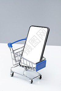 手机智能网上购物灰色背景移动支付智能手机购物车和空白屏幕的手机背景