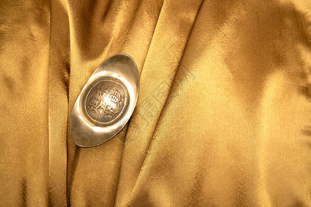 金色物体金色投资一个物体金缎上的金元宝背景