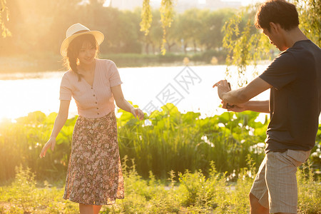 休闲活动生态旅游约会幸福情侣在公园里拍照高清图片
