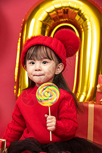 红色礼物影棚拍摄可爱的小女孩拿着棒棒糖图片