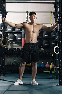 吊环运动运锻炼年轻男子在健身房健身背景