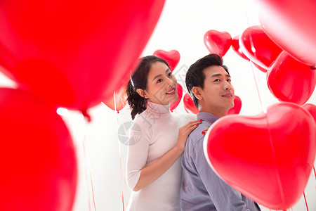 爱心气球下的浪漫情侣背景图片