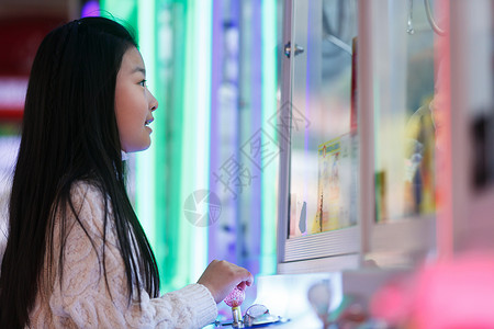 可爱的女孩在游戏厅玩耍图片