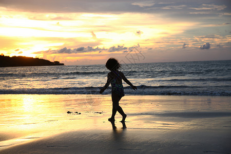 跑步金色人傍晚巴厘岛海景剪影背景