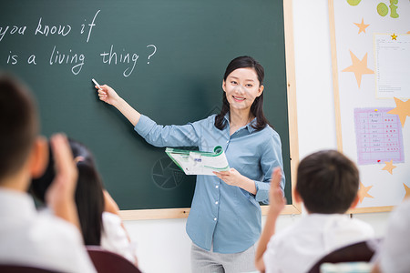 老师和小学生们在教室里背景图片