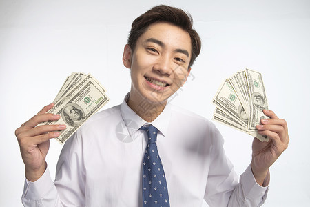 人东亚成功商务青年男人拿着美元图片