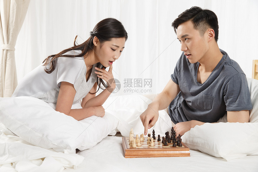 健康的20到24岁满意青年情侣下象棋图片