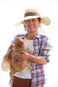 民草帽中年女人拿着一只鸡图片