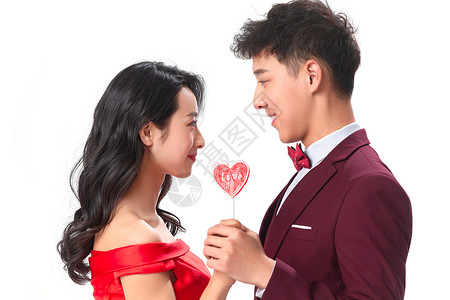 青年女人正装两个人浪漫情侣拿着心形棒棒糖图片