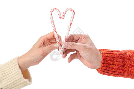 浪漫男人心字体青年情侣拿着拐杖糖组成心的形状背景