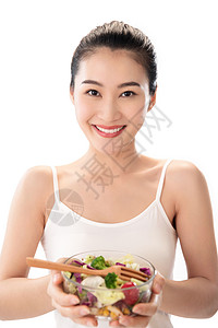 刀叉新鲜体型青年女人吃沙拉图片