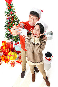 圣诞网红素材青年人青年情侣用手机照相背景