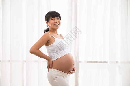 孕育手放在肚子上20多岁幸福的孕妇图片