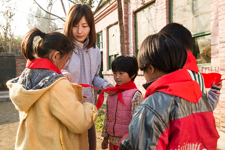 青年人关爱玩耍乡村教师和小学生在学校里图片