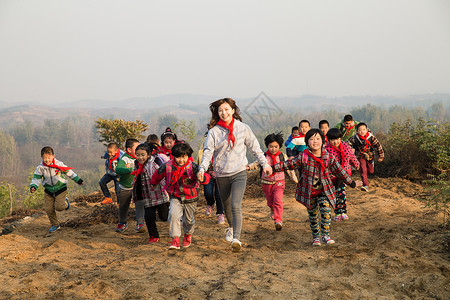 为梦想奔跑人相伴青年人天真乡村女教师和学生在玩耍背景