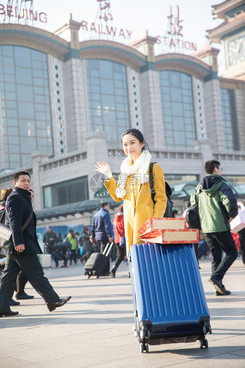 等待购物袋人青年女人在站前广场图片