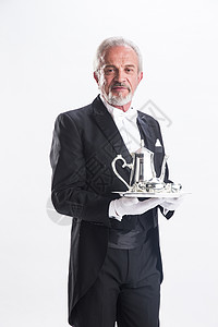 银级服务彩色图片豪华酒店60到64岁一个男侍者托着银餐具背景