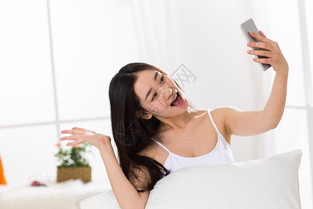 智能手机独处青年人青年女人在卧室自拍图片