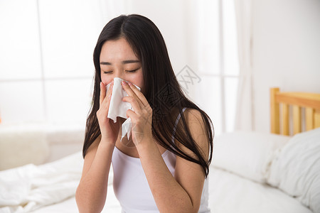 早晨发热打喷嚏青年女人生病背景图片