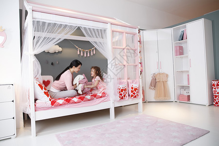 床摄影奢华可爱的小女孩和妈妈在卧室玩耍高清图片